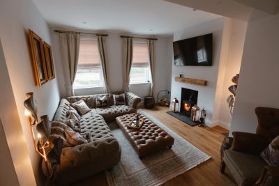 The sitting room at Willow Lodge with a lit wood burning stove