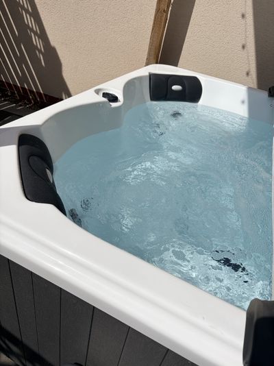 The private outdoor hot tub in the garden at Willow Lodge