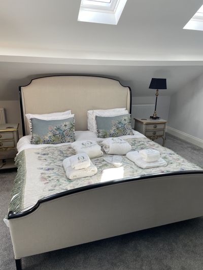 A superking bedroom with crisp cotton bedding at Willow Lodge